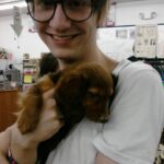 me holding cute puppy at pet store