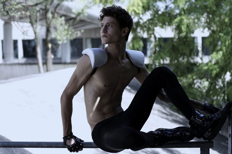 Model in futuristic outfit posed against urban backdrop