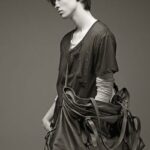 Stylish male model with a large bag in monochrome fashion.