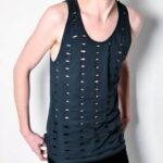 Model wearing charcoal hole-in-one singlet with unique cutouts.