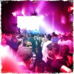 Crowd dancing at MSTRKRFT concert in vibrant lighting.