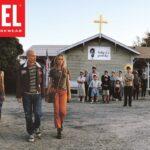 Group of people outside a building with a positive message banner.