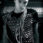 Fashionable model wearing cable accessories against a recording studio backdrop.