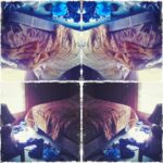 A cozy boy's room with an unmade bed and scattered clothes.