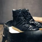 Black leather lace-up sneakers in a stylish setting.