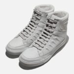 White Givenchy studded high top sneakers on display.