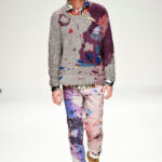Fashion model wearing James Long S/S '11 colorful knitwear and pants.
