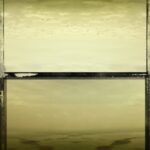 Moody aerial view of a hazy harbor landscape.