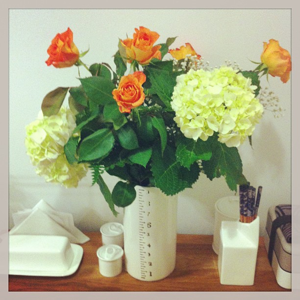 Hydrangeas and orange roses