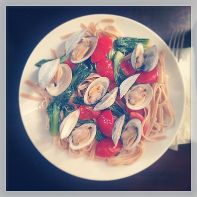 Little Neck Clams in lemon and white wine sauce with sautéed bok choy and vine tomatoes